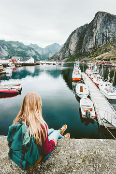 Tourist woman enjoying fjord view of Lofoten islands in Norway Travel lifestyle concept adventure outdoor summer vacations