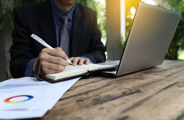 banker businessman people group working with laptop and financial document chart on wood table together.