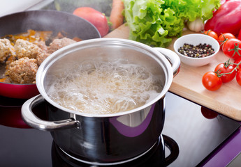Cooking spaghetti in a pot with boiling water