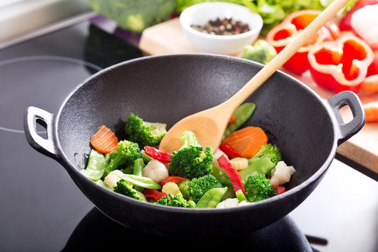 cooking stir fried vegetables in a wok
