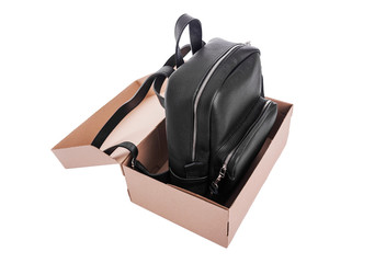 Leather backpack in a cardboard box.