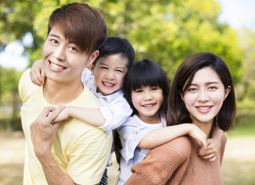 Portrait Of Happy asian Family In the park.