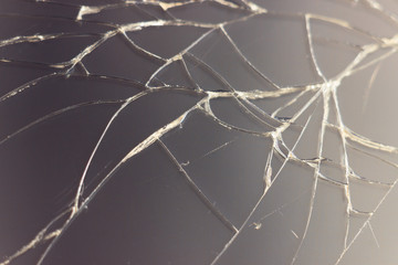Close-up macro of broken dark glass. Abstract black background with white lines. Elements of...