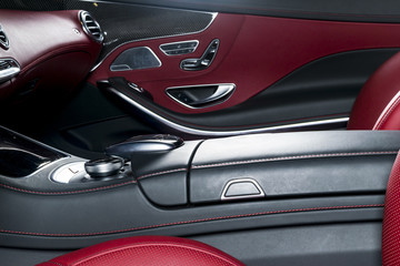 Fototapeta na wymiar Modern Luxury car inside. Interior of prestige modern car. Comfortable leather seats. Red perforated leather cockpit. Modern car interior details