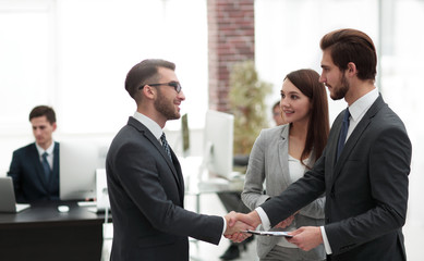 Young man introducing himself at meeting to his partners.