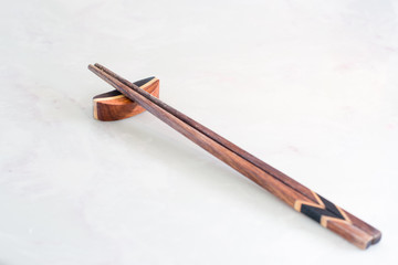Wooden chopsticks on chopstick rest