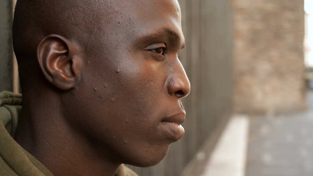 close up on sad african black man-outdoor