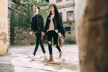 Spring photo session of a beautiful young couple in the old courtyards of the city.