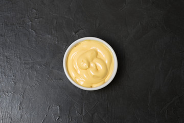 Cheese sauce on a black background. Place for your text.