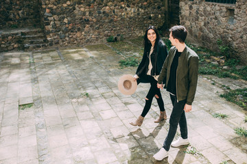 Spring photo session of a beautiful young couple in the old courtyards of the city.