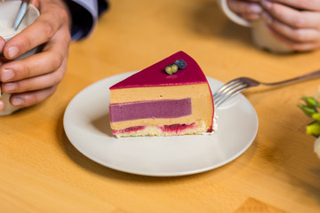 couple drinks coffee with fruit cakes at a cafe