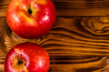 Ripe red apples on the wooden table. Top view