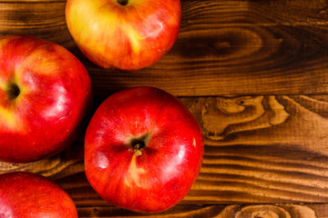 Ripe red apples on the wooden table. Top view