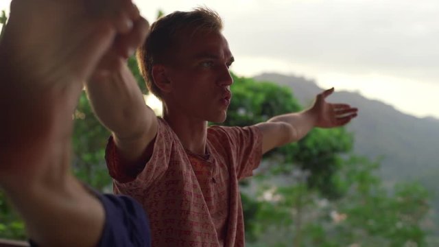 Close up man do standing hand toe yoga pose at balcony sunrise rapid slow motion