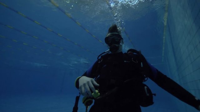 Scuba dive instructor showing hand gesture for underwater communication