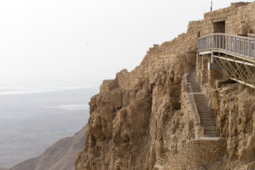 Inaccessible walls of the Masada National Park on the background of the Judean Desert