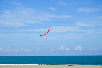 Colourful kite over  the blue sky.