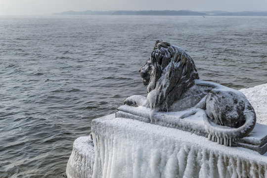 Ice-covered Bavarian Lion on a frosty winter day in Tutzing on Lake Starnberg