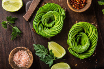 toast with avocado roses on wooden cutting board