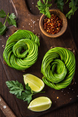 toast with avocado roses on wooden cutting board