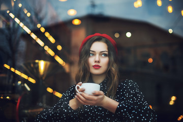 Young beautiful fashionable girl with red lips, wearing french style beret and polka dot blouse...