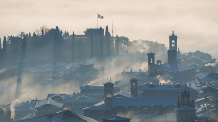 Fototapeta premium Bergamo, one of the most beautiful city in Italy. Lombardy. Amazing landscape of the fog rises from the plains and covers the old town