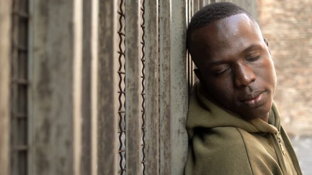 Relaxed attractive toung black man staring at camera- outdoor