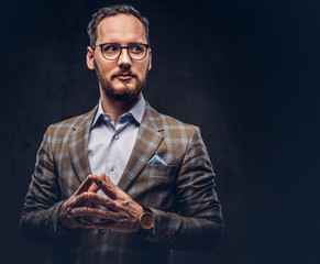 Studio portrait of a bearded hipster in glasses wearing a casual