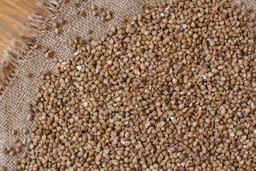 Buckwheat. Buckwheat on wood background and burlap top view