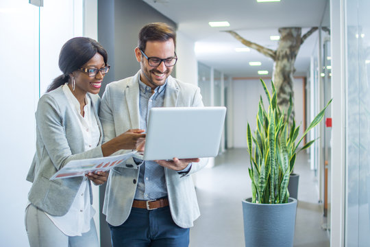 Business People With Laptop Discussing About New Business Offer For The Company They Received On Email.