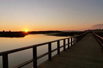 Fototapeta na wymiar Alvor, Algarve, wooden trail in sunset in a natural wetland, ribeira do odiaxere