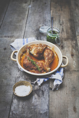 roast chicken with pesto on wooden background