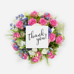 Fresh flowers bunch and card with words thank you written on it