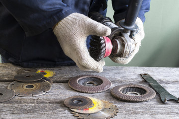 A man works with a grinding machine.