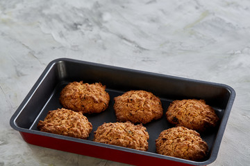 Fresh baked chocolate cookies on a cookie sheet, top view, close-up, selective focus