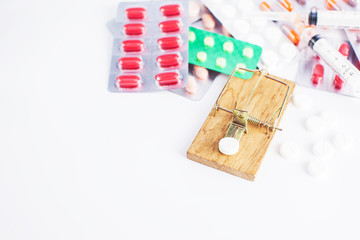 pills and mouse trap isolated on white