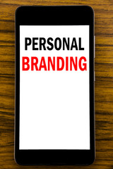 Handwriting Announcement text showing Personal Branding. Business concept for Brand Building Written on mobile phone cellphone with wooden background with space on the table