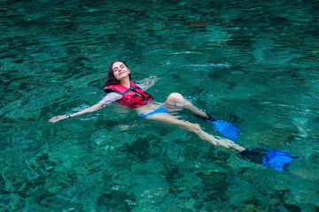 Women snorkeling in clear water on the beach Islands. Girl dives under the sea.