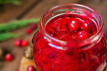 Berries cranberries, drink, jam spruce branches, cones on a dark background with a copy of the space