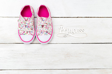Girl's sneakers and the word princess. Flat lay