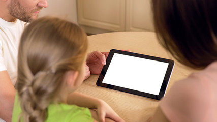 Happy family using application on tablet pc with pre-keyed green touchscreen