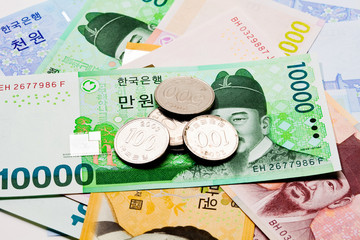 Banknote of korea won currency with coins.