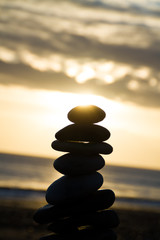 pebbles towered on the beach during the sunrise