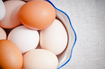 raw hen eggs in vintage bowl like in rustic styl like a concept for organic, classic, farm cooking and Easter 