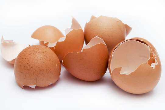 broken hen egg eggshels over white background like a concept of fragile, Easter, cooking