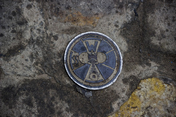 Fototapeta na wymiar iron manhole on the pedestrian road