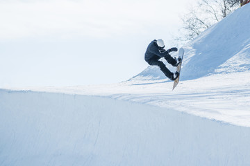 People are enjoying half-pipe skiing	/ snowboarding