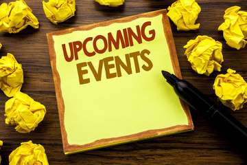 Fototapeta premium Hand writing text caption showing Upcoming Events. Business concept for Appointment Agenda List Written on sticky note paper, wooden background with marker folded yellow paper meaning thinking
