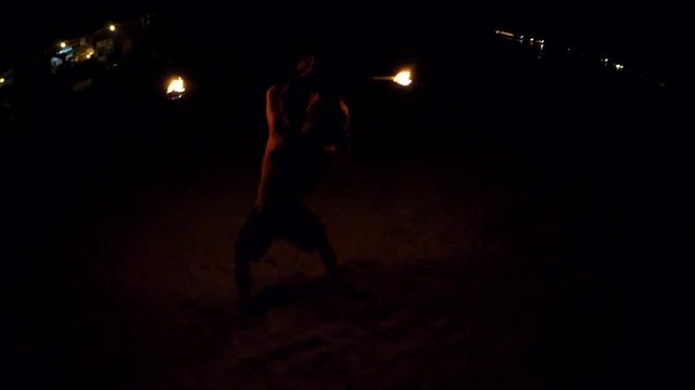 Man Performing A Dance With Fire On Beach