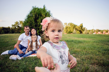 Fototapeta premium Close-up portrait of a very sweet little girl. Happy kid in the park. 